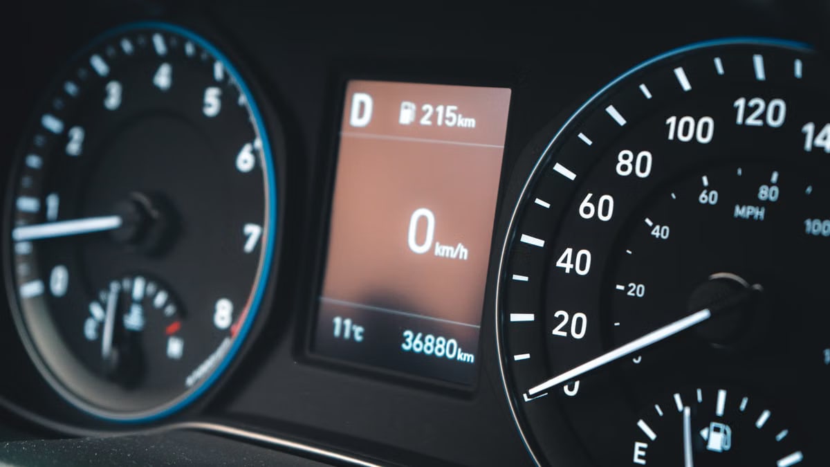 Detailed view of a car dashboard featuring speedometer and digital display showing 0 km/h.